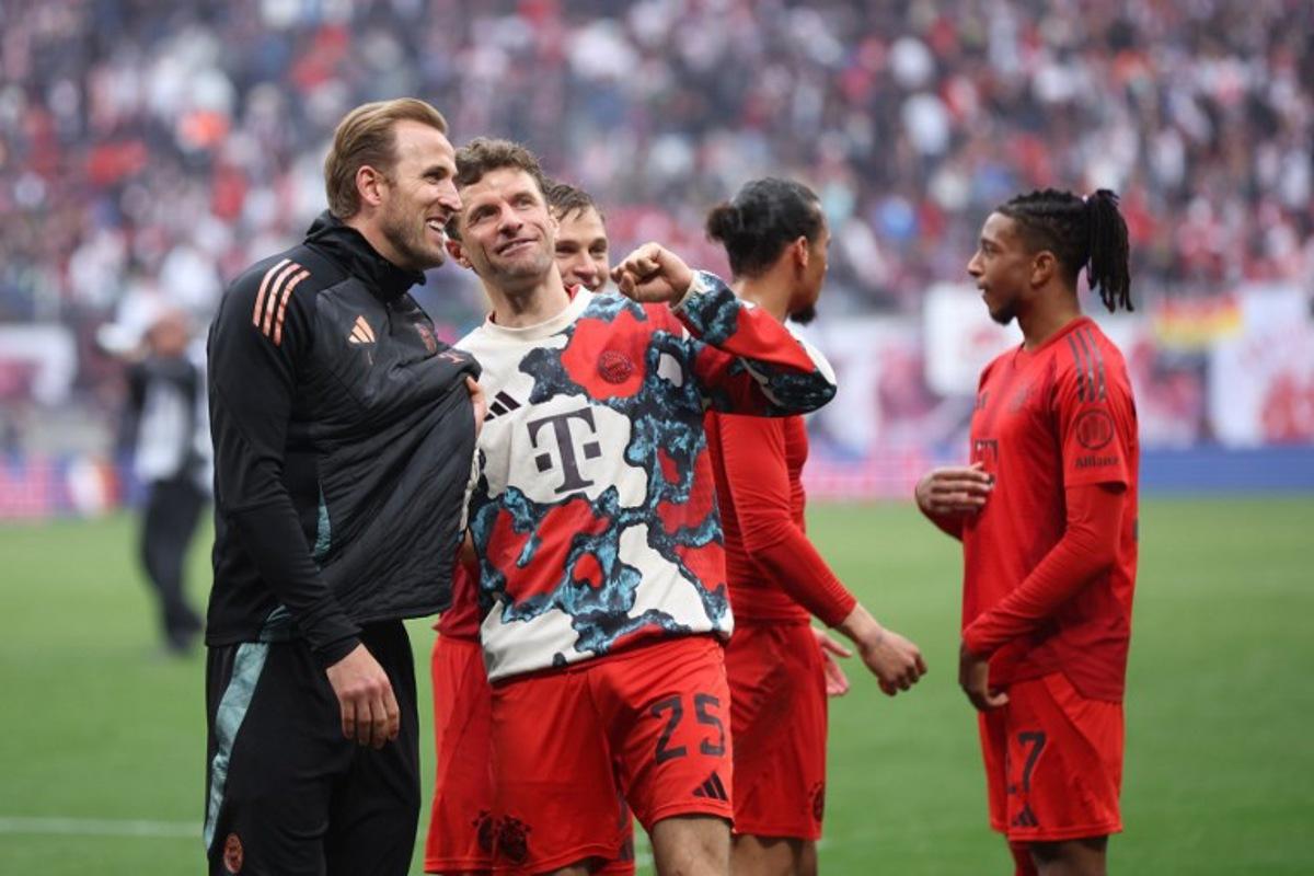 Bayern Munich's German forward #25 Thomas Mueller (2L) and Bayern Munich's English forward #09 Harry Kane talk after the German first division Bundesliga football match between RB Leipzig and FC Bayern Munich in Leipzig, eastern Germany on May 3, 2025. Ronny HARTMANN / AFP