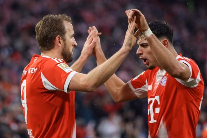 Bayern Munich's English forward #09 Harry Kane celebrates scoring the 3-0 goal with his teammate Bayern Munich's German midfielder #45 Aleksandar Pavlovic during the German first division Bundesliga football match between FC Bayern Munich and Eintracht Frankfurt in Munich, southern Germany, on February 21, 2026. Alexandra BEIER / AFP