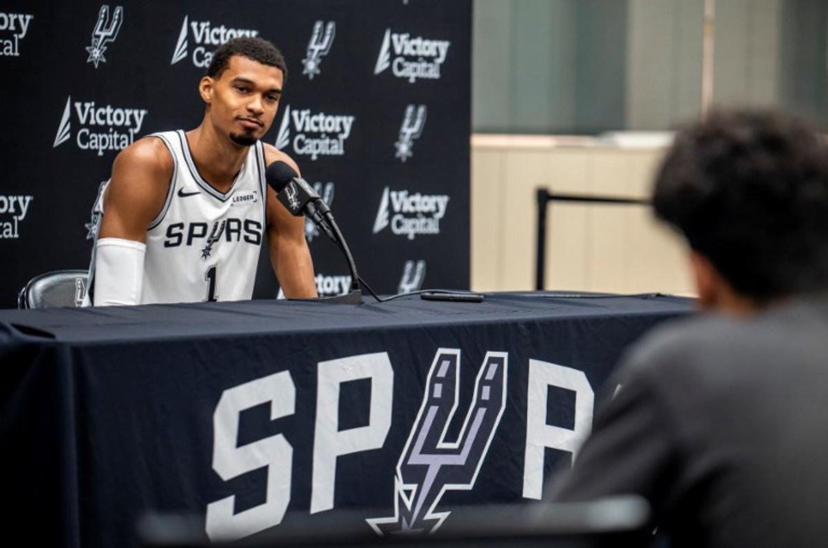French basketball player Victor Wembanyama speaks to journalists during the San Antonio Spurs media day at the Victory Capital Performance Center in San Antonio, Texas on September 29, 2025. Wembanyama has been cleared by the team's medical staff to play for the upcoming season. SERGIO FLORES / AFP