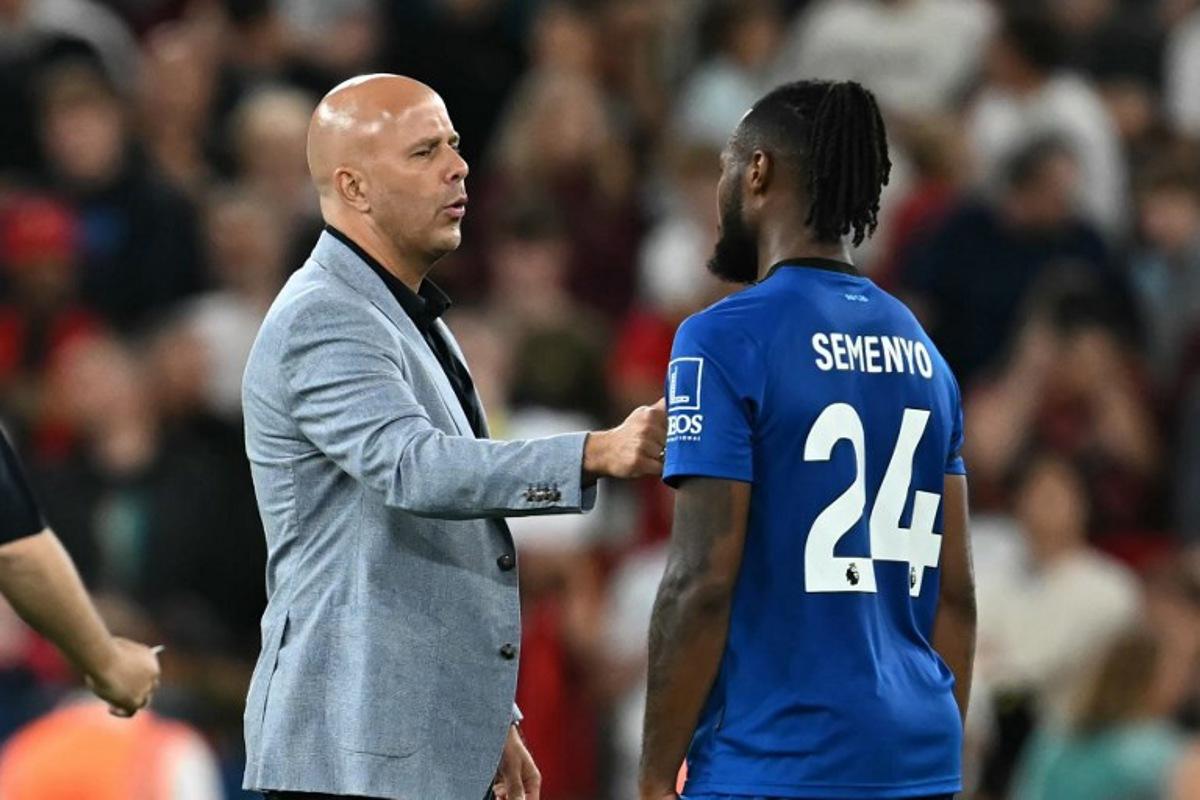 Liverpool's Dutch manager Arne Slot speaks with Bournemouth's Ghanaian striker #24 Antoine Semenyo after the English Premier League football match between Liverpool and Bournemouth at Anfield in Liverpool, north west England on August 15, 2025. Liverpool won the game 4-2. Paul ELLIS / AFP