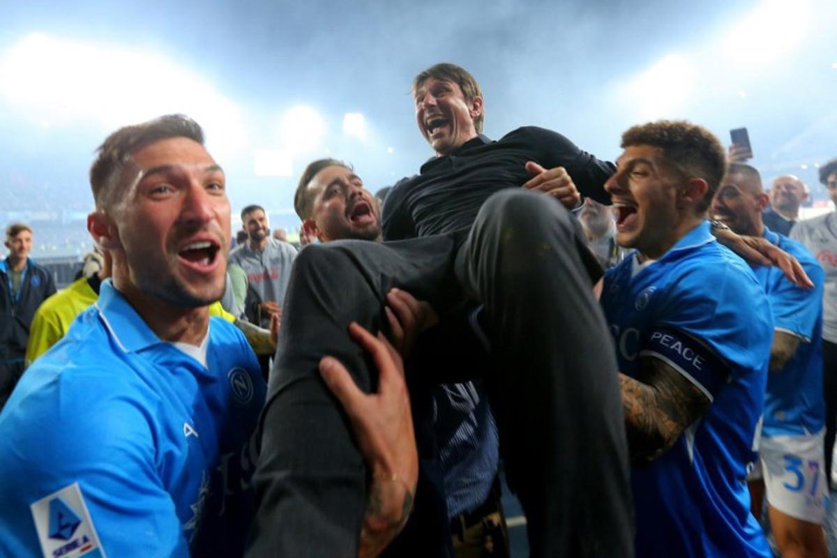 Napoli's Italian coach Antonio Conte is thrown in the air by his players as they celebrate after winning Italian Serie A football match between Napoli and Cagliari at the Diego Armando Maradona stadium in Naples on May 23, 2025. Carlo Hermann / AFP