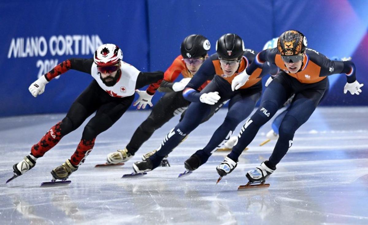 Canada's Steven Dubois, China's Liu Shaoang, Netherlands' Teun Boer and Netherlands' Jens van 't Wout compete in the short track speed skating men's 500m semi-final during the Milano Cortina 2026 Winter Olympic Games at Milano Ice Skating Arena in Milan on February 18, 2026. WANG Zhao / AFP