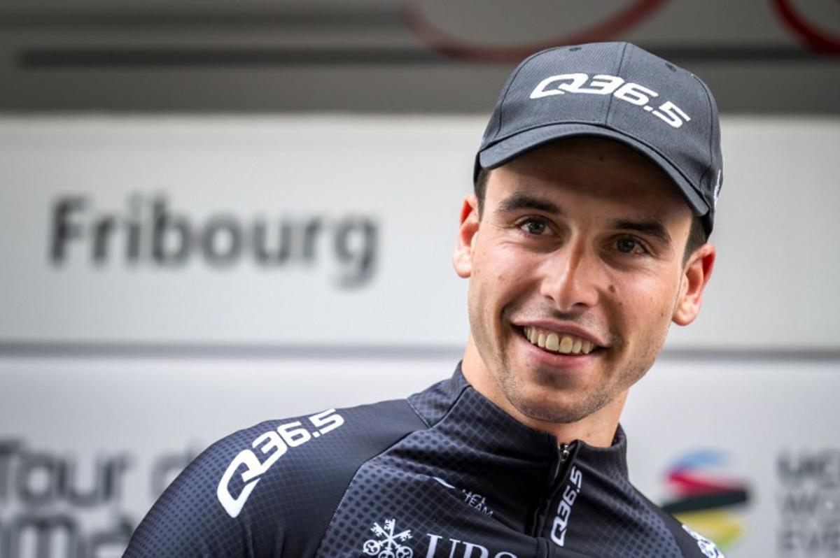 Swiss cyclist Fabio Christen of Q36.5 Pro Cycling team smiles after being awarded best Swiss rider during the podium ceremony of the first stage of the Tour of Romandy UCI cycling World tour 165,7 km from Chateau d'Oex to Fribourg, on April 24, 2024. Fabrice COFFRINI / AFP