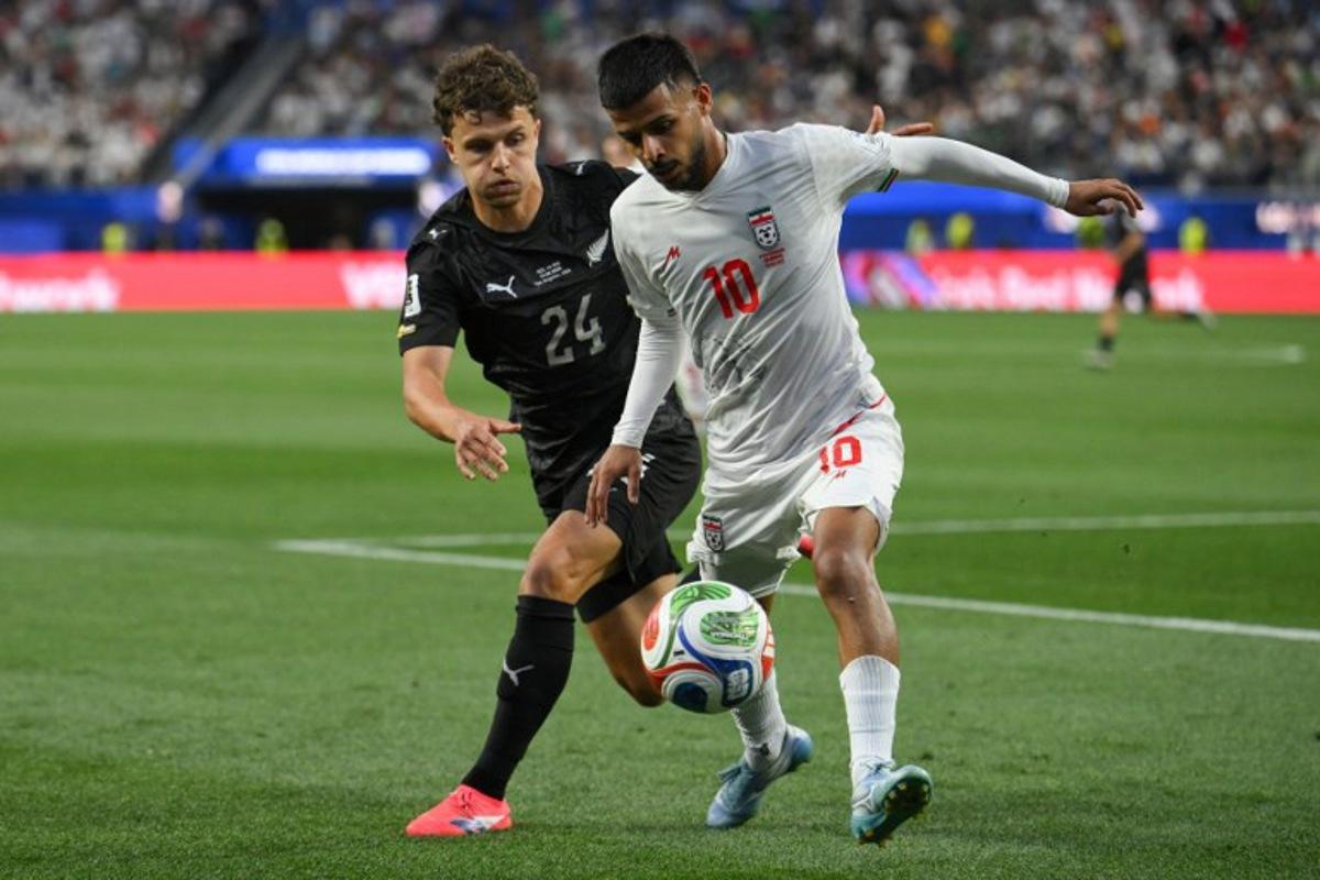 New Zealand's defender #24 Callan Elliot and Iran's midfielder #10 Mehdi Ghayedi fight for the ball during the 2026 World Cup Group G football match between Iran and New Zealand at Los Angeles Stadium in Inglewood on June 15, 2026. Patrick T. Fallon / AFP