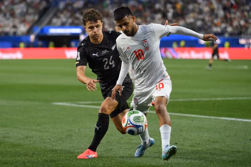 New Zealand's defender #24 Callan Elliot and Iran's midfielder #10 Mehdi Ghayedi fight for the ball during the 2026 World Cup Group G football match between Iran and New Zealand at Los Angeles Stadium in Inglewood on June 15, 2026. Patrick T. Fallon / AFP