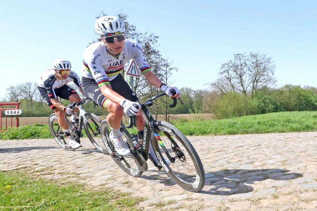 UAE Emirates-XRG's Slovenian rider Tadej Pogacar (R) rides with his team over the cobblestones of the "trench" of Brillon, northern France, on April 9, 2026, to reconnoiter the cobblestones of the 123rd Paris-Roubaix race, which will take place on April 12. Francois LO PRESTI / AFP