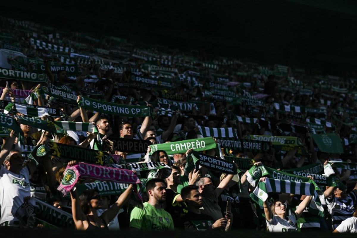 Sporting supporters cheer during the Portuguese League football match between Sporting CP and Vitoria Guimaraes SC at Jose Alvalade stadium in Lisbon, on May 17, 2025. PATRICIA DE MELO MOREIRA / AFP