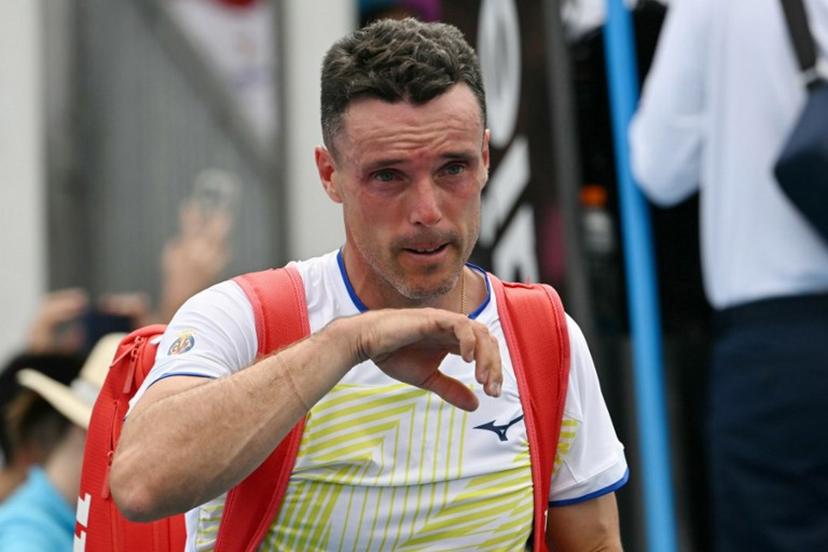 Spain's Roberto Bautista Agut leaves the court after his defeat against China's Shang Juncheng in their men's singles match on day two of the Australian Open tennis tournament in Melbourne on January 19, 2026. Paul Crock / AFP