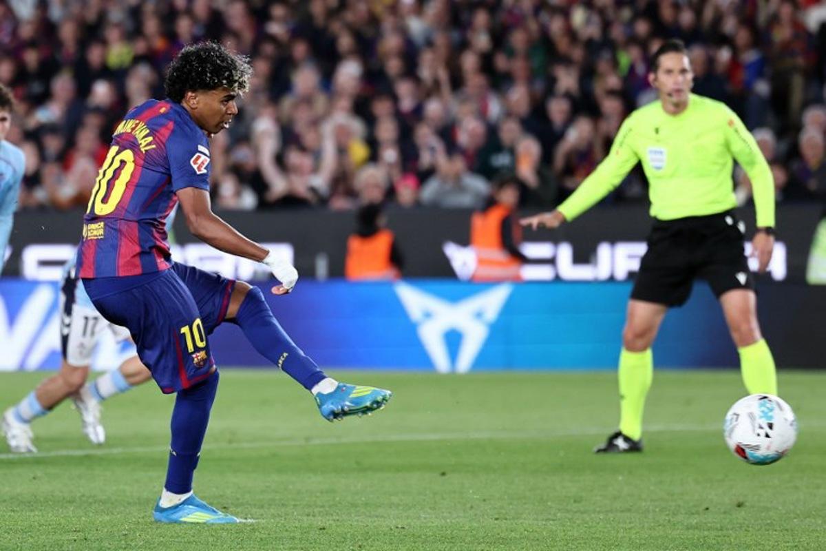 Barcelona's Spanish forward #10 Lamine Yamal scores the opening goal from the penalty spot during the Spanish league football match between FC Barcelona and RC Celta de Vigo at Camp Nou stadium in Barcelona on April 22 , 2026. Josep LAGO / AFP
