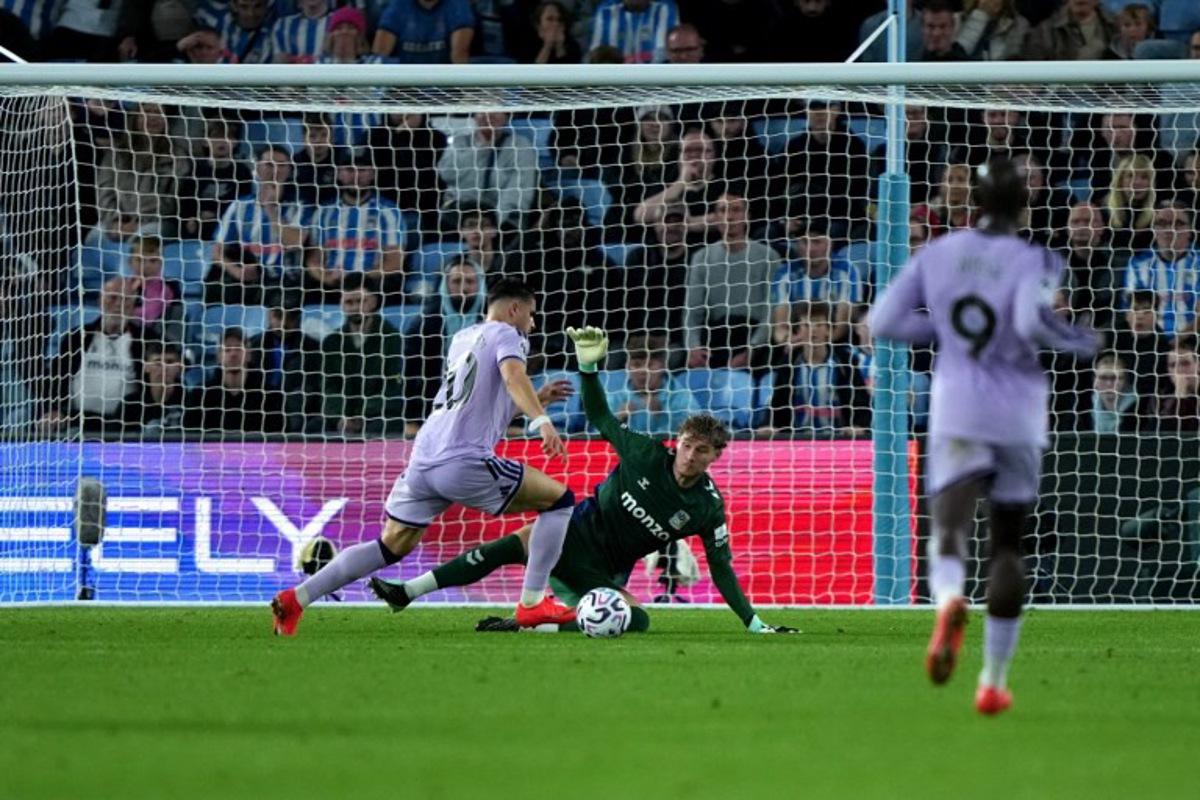 Coventry City's English goalkeeper #19 Carl Rushworth saves a shot from Newcastle United's Belgian striker #20 Matias Fernandez-Pardo during the English Premier League football match between Coventry City and Newcastle United at the Coventry Building Society Arena in Coventry, central England on October 12, 2026. Ben Stansall / AFP