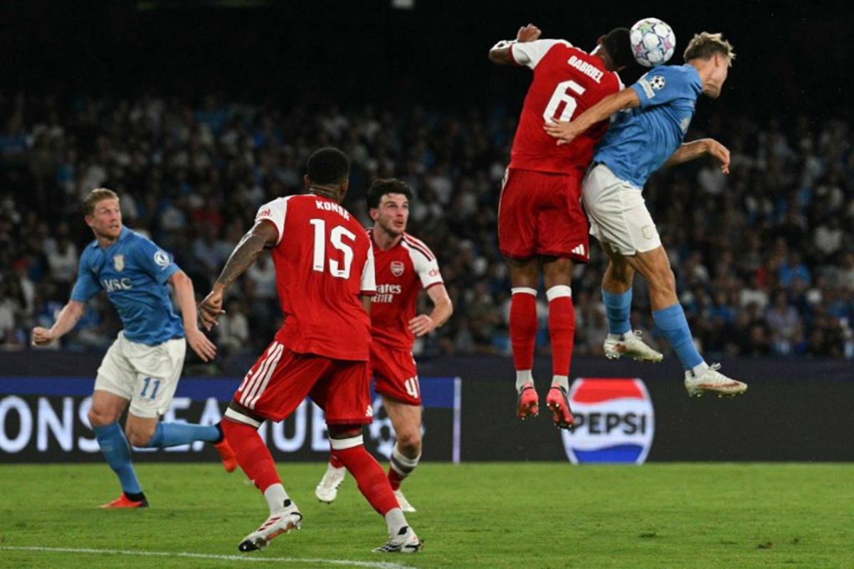 Arsenal's Brazilian defender #06 Gabriel and Napoli's Belgian midfielder #11 Kevin De Bruyne jump to head the ball during the UEFA Champions League - League Phase, Matchday 1 - football match between Napoli and Arsenal at the Stadio Diego Armando Maradona in Naples on September 9, 2026. Andreas SOLARO / AFP