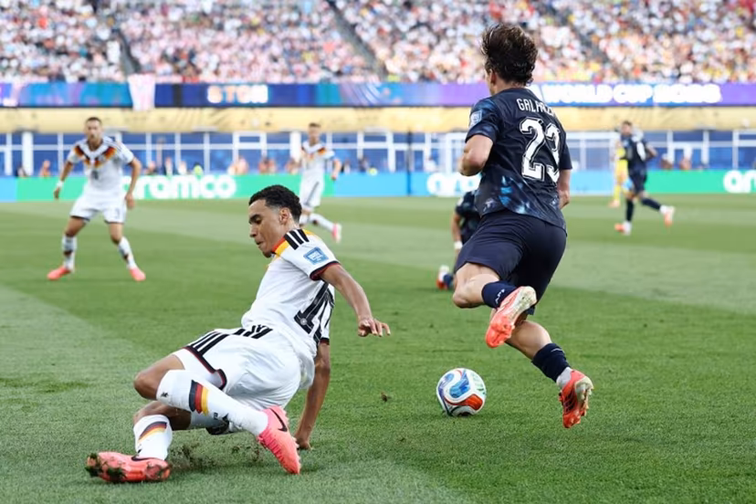 Germany's midfielder #10 Jamal Musiala (L) fouls Paraguay's midfielder #23 Matias Galarza during the 2026 World Cup round of 32 football match between Germany and Paraguay at the Boston Stadium in Foxborough on June 29, 2026. CHARLY TRIBALLEAU / AFP