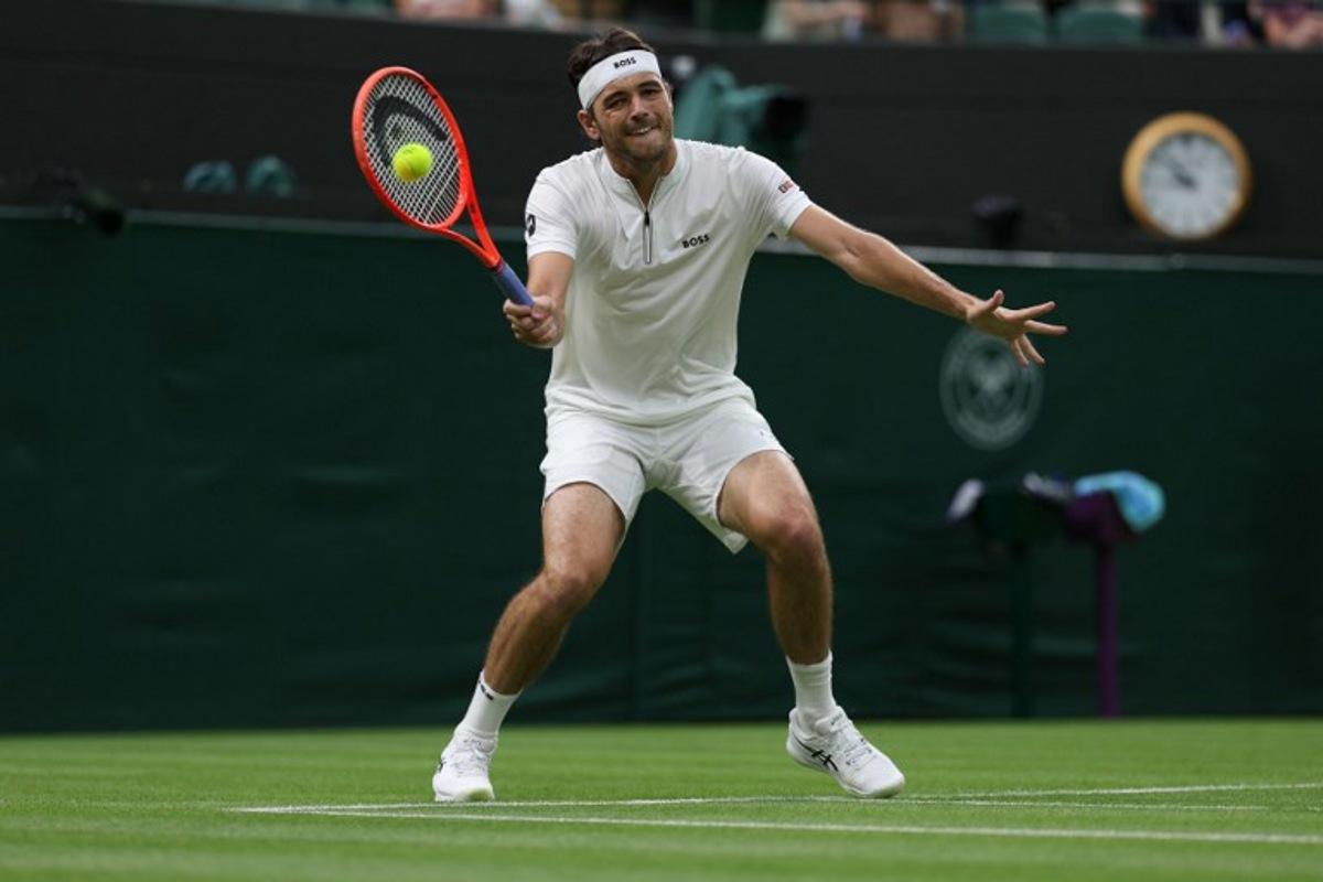 US Taylor Fritz plays a forehand return to France's Giovanni Mpetshi Perricard during their men's singles first round tennis match on the first day of the 2025 Wimbledon Championships at The All England Lawn Tennis and Croquet Club in Wimbledon, southwest London, on June 30, 2025. Adrian Dennis / AFP