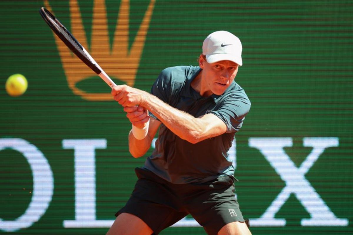 Italy's Jannik Sinner plays a backhand return to Czech Republic's Tomas Machac during their Monte Carlo ATP Masters Series Tournament round of 16 tennis match on Court Rainier III at the Monte-Carlo Country Club in Roquebrune-Cap-Martin, south-eastern France on April 9, 2026. Valery HACHE / AFP