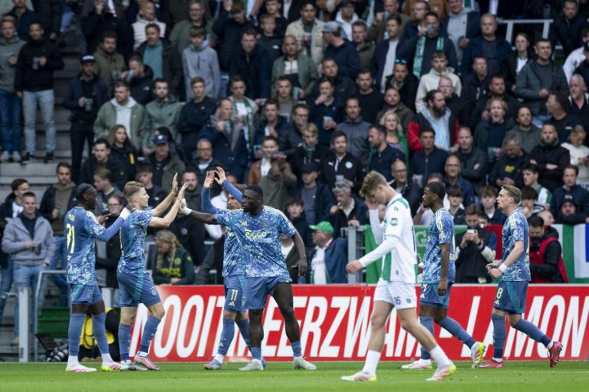 Ajax's Dutch forward #09 Brian Brobbey (C) celebrates with teammates after scoring the opening goal during the Dutch Eredivisie football match between FC Groningen and Ajax Amsterdam at Euroborg Stadium in Groningen on May 14, 2025. Robin van Lonkhuijsen / ANP / AFP