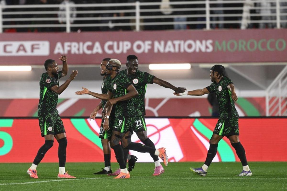 Nigeria's forward #09 Victor Osimhen (3L) celebrates scoring the team's second goal during the Africa Cup of Nations (CAN) round of 16 football match between Nigeria and Mozambique at the Sports Complex stadium in Fes on January 5, 2026. SEBASTIEN BOZON / AFP