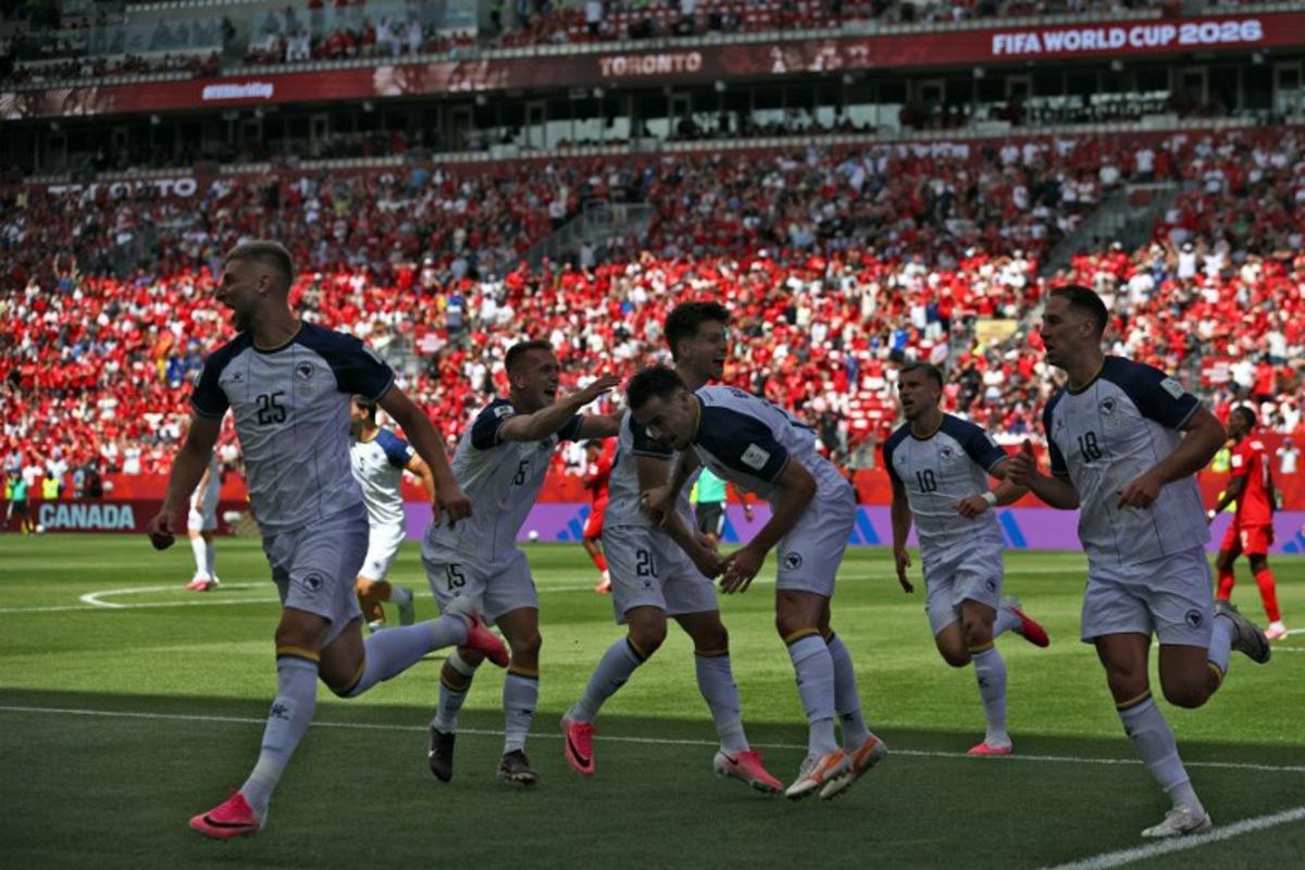 Bosnia-Herzegovina's forward #25 Jovo Lukic (L) celebrates after scoring a goal during the 2026 World Cup Group B football match between Canada and Bosnia and Herzegovina at the Toronto Stadium in Toronto on June 12, 2026. Cole Burston / AFP