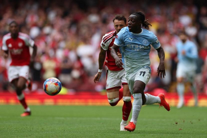 Manchester City's Belgian midfielder #11 Jeremy Doku runs with the ball during the English FA Community Shield football match between Arsenal and Manchester City at The Principality Stadium, in Cardiff, south Wales on August 16, 2026. Adrian Dennis / AFP