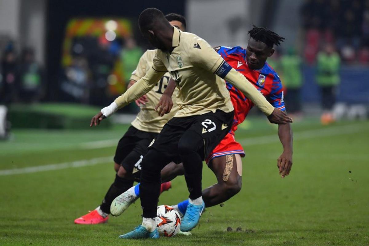 Ferencvaros' French defender #27 Ibrahim Cisse (L) and Viktoria Plzen's Ghanaian forward #80 Prince Kwabena Abu (R) vie for the ball during the UEFA Europa League knockout round play-off 2nd leg football match between FC Viktoria Plzen and Ferencvaros in Plzen, Czech Republic, on February 20, 2025. Michal Cizek / AFP
