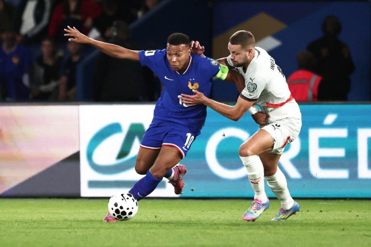 France's forward #10 Kylian Mbappe (L) fights for the ball with Iceland's defender #05 Sverrir Ingason during the FIFA World Cup 2026 Group D European qualification football match between France and Iceland at the Parc des Princes stadium in Paris, on September 9, 2025. Thibaud MORITZ / AFP