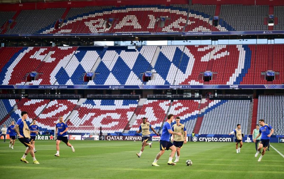 Inter Milan's players attend the MD-1 training session in front of the logo of Bayern Munich on the eve of the UEFA Champions League final football match between Inter Milan and Paris Saint-Germain (PSG) at the Allianz-Arena stadium in Munich, southern Germany, on May 30, 2025. Marco BERTORELLO / AFP