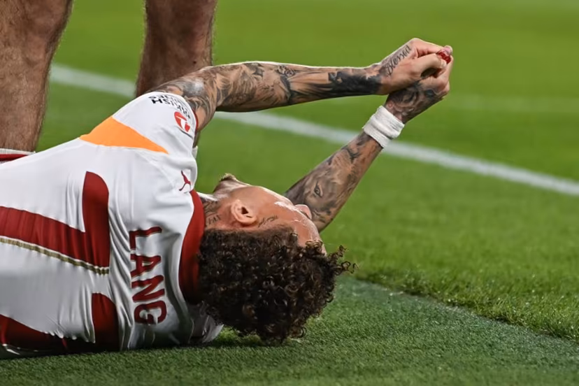 Galatasaray's Dutch forward #77 Noa Lang reacts on the floor after cutting his thumb during the UEFA Champions League, round of 16 second leg football match between Liverpool and Galatasaray at Anfield in Liverpool, north-west England on March 18, 2026. Paul ELLIS / AFP