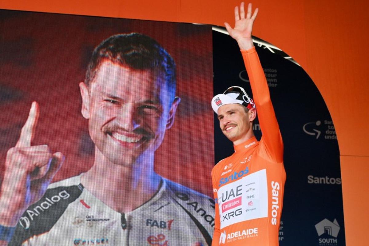 Race leader UAE Team Emirates XRG's Australian rider Jay Vine waves onstage as he continues to wear the leader's jersey after stage four of the Tour Down Under UCI men's cycling race in Adelaide on January 24, 2026. Brenton Edwards / AFP
