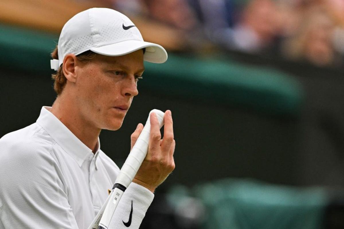 Italy's Jannik Sinner blows on his hand as he plays against Spain's Pedro Martinez during their men's singles third round tennis match on the sixth day of the 2025 Wimbledon Championships at The All England Lawn Tennis and Croquet Club in Wimbledon, southwest London, on July 5, 2025. Glyn KIRK / AFP