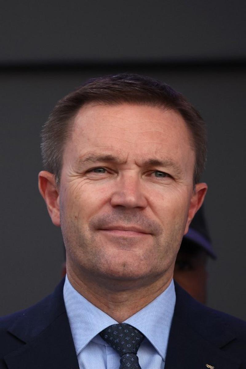 UCI President David Lappartient stand with medal winners on the podium following the team time trial mixed relay cycling event during the UCI 2025 Road World Championships, in Kigali, on September 24, 2025. Anne-Christine POUJOULAT / AFP