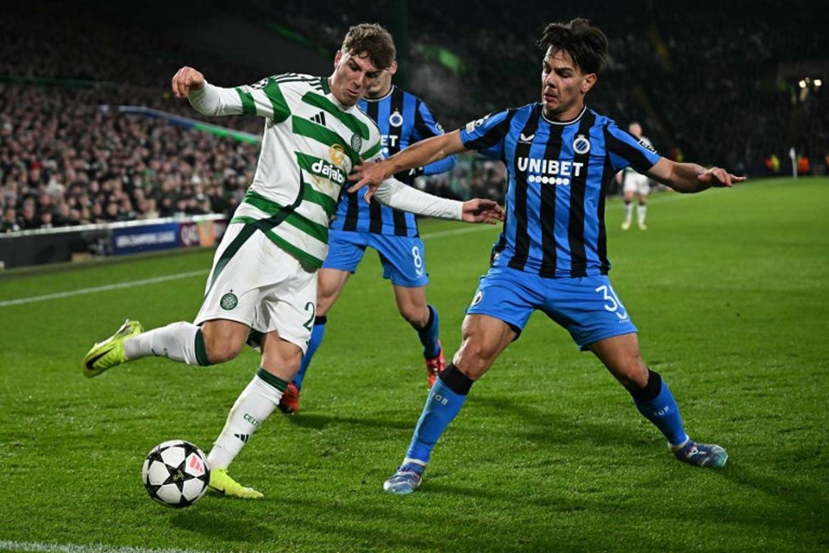 Club Brugge's Swiss midfielder #30 Ardon Jashari (R) defends from Celtic's Belgian midfielder #27 Arne Engels during the UEFA Champions League football match between Celtic and Club Brugge at Celtic Park stadium in Glasgow, Scotland on November 27, 2024. Paul ELLIS / AFP