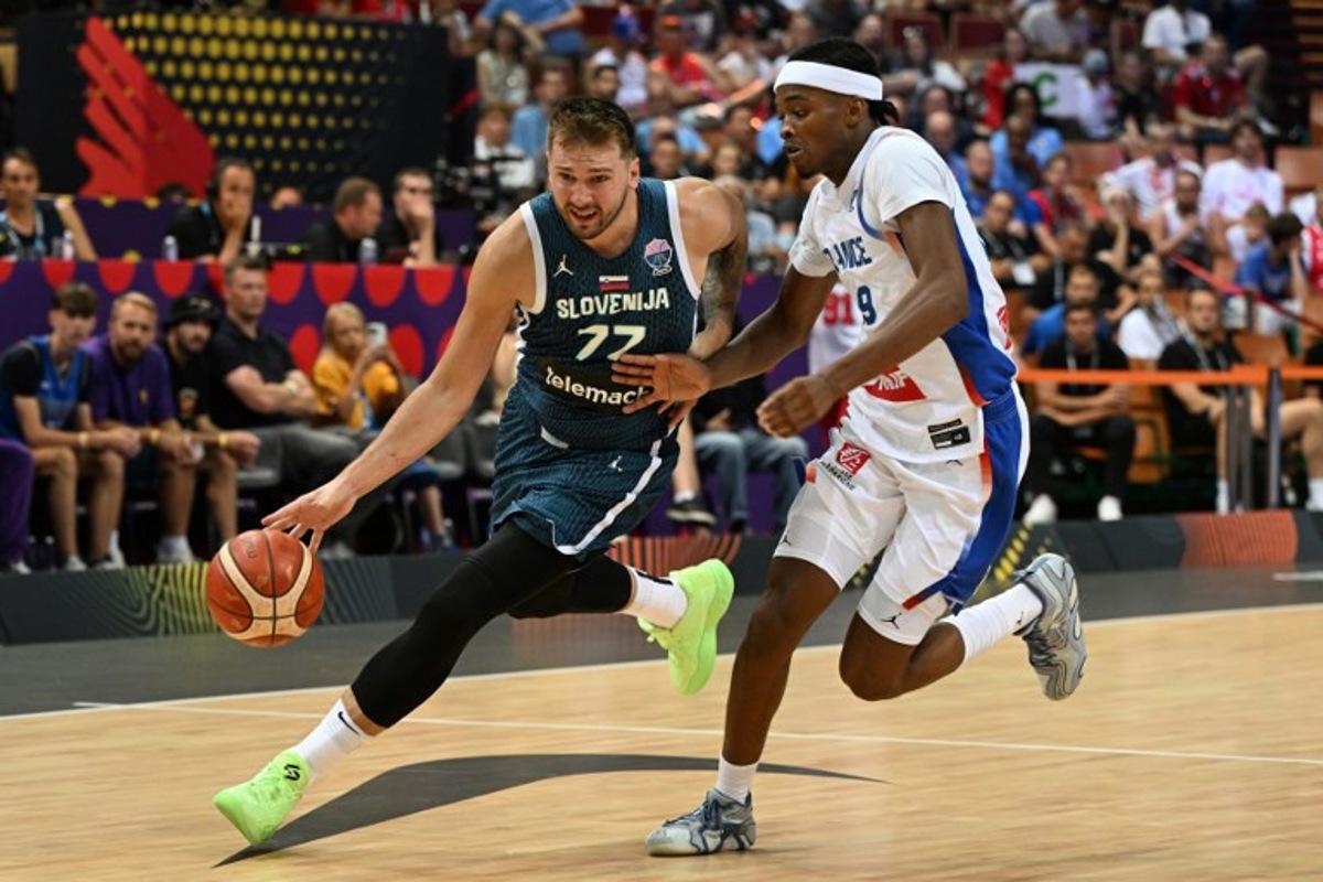 Slovenia's guard #77 Luka Doncic (L) and France's shooting guard #99 Bilal Coulibaly (R) vie during the FIBA EuroBasket 2025 Group D basketball match between France and Slovenia at the Spodek Arena in Katowice, Poland on August 30, 2025. Sergei GAPON / AFP