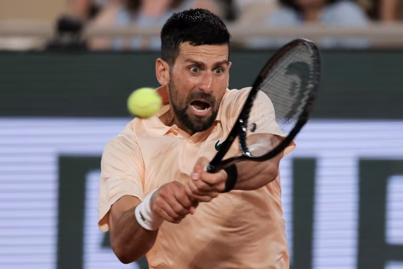 Serbia's Novak Djokovic plays a backhand return to France's Giovanni Mpetshi Perricard during their men's singles match on day 1 of the French Open tennis tournament on Court Philippe-Chatrier at the Roland-Garros Complex in Paris on May 24, 2026. Thomas SAMSON / AFP