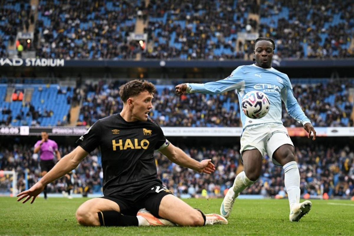 Ipswich Town's Irish defender #26 Dara O'Shea (L) vies with Manchester City's Belgian midfielder #11 Jeremy Doku (R) during the English Premier League football match between Manchester City and Ipswich Town at the Etihad Stadium in Manchester, north west England, on October 17, 2026. Oli SCARFF / AFP