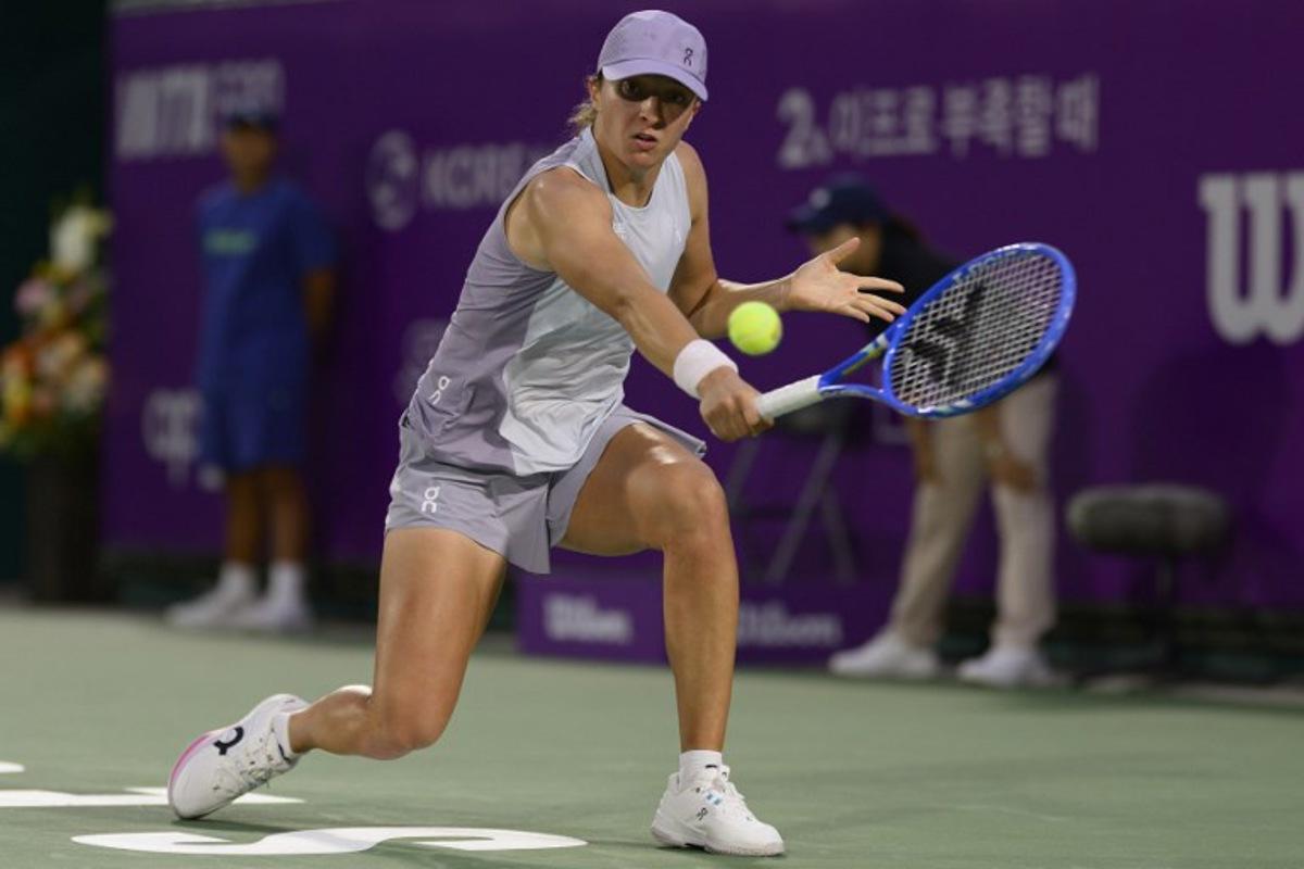 Iga Swiatek of Poland hits a return to Maya Joint of Australia during their women's singles semi-final match at the Korea Open tennis tournament in Seoul on September 20, 2025. ANTHONY WALLACE / AFP