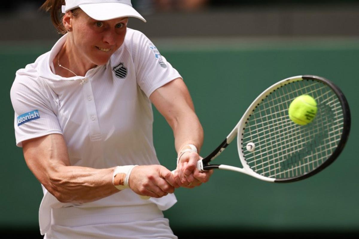 Russia's Liudmila Samsonova plays a backhand return to Poland's Iga Swiatek during their women's singles quarter-final tennis match on the tenth day of the 2025 Wimbledon Championships at The All England Lawn Tennis and Croquet Club in Wimbledon, southwest London, on July 9, 2025. HENRY NICHOLLS / AFP