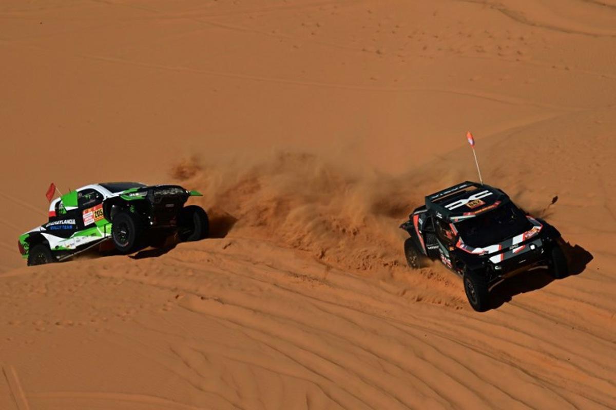 The Dacia Sandriders's (L) Qatari driver Nasser Al‑Attiyah and Belgian co‑pilot Fabian Lurquin and Polish driver Energylandia Rally Team's Eryk Goczal and Polish co‑pilot Szymon Gospodarczyk compete in the Stage 6 of the 48th edition of the Dakar Rally 2026, between Hail and Riyadh, Saudi Arabia, on January 9, 2026. Giuseppe CACACE / AFP