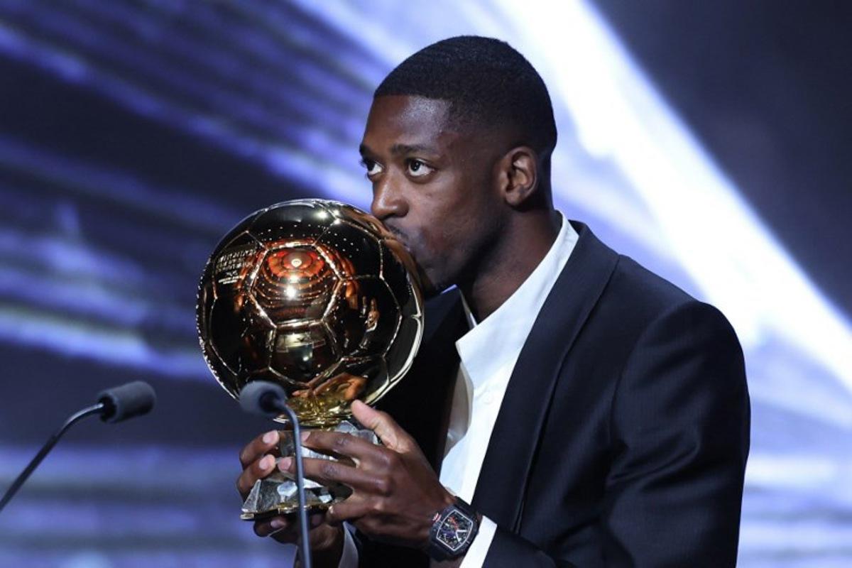 Paris Saint-Germain's French forward Ousmane Dembele kisses the Ballon d'Or award during the 2025 Ballon d'Or France Football award ceremony at the Theatre du Chatelet in Paris on September 22, 2025. Franck FIFE / AFP