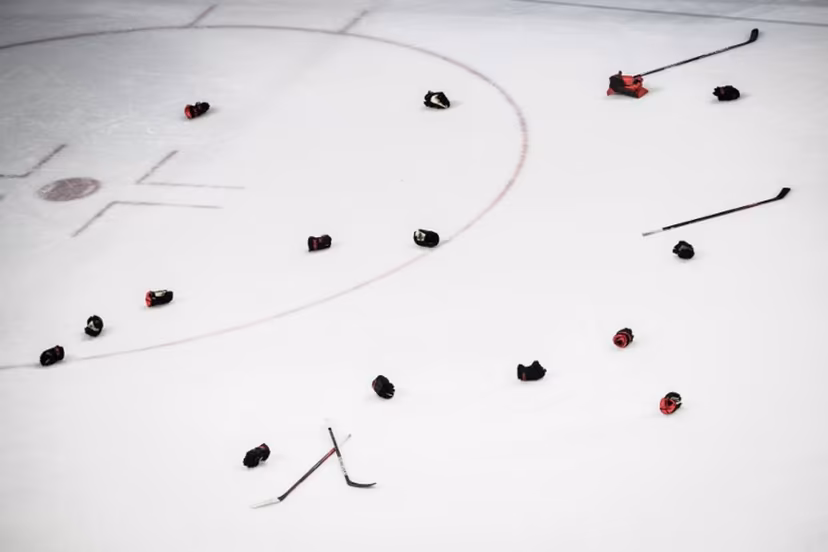 Canadian players' gloves and sticks are seen after their victory during the women's gold medal match of the Beijing 2022 Winter Olympic Games ice hockey competition between Canada and USA, at the Wukesong Sports Centre in Beijing on February 17, 2022. Jeff PACHOUD / AFP