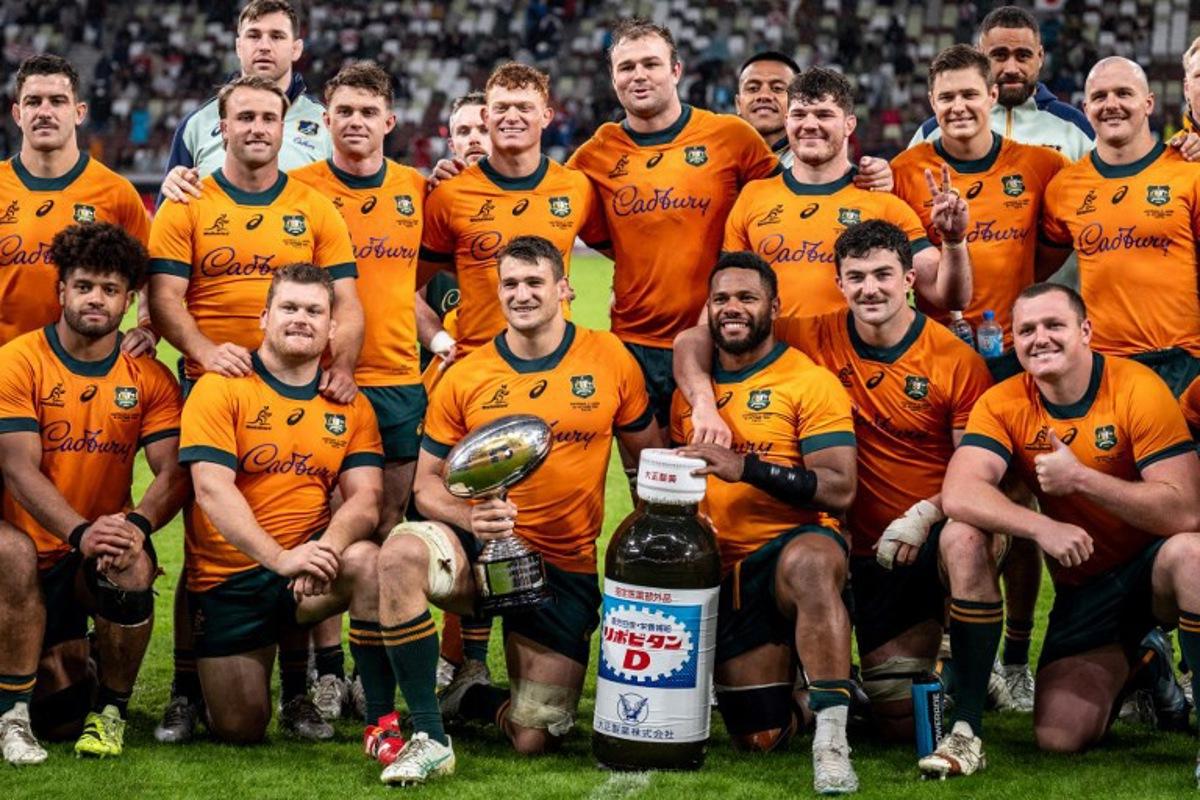 Australia players pose with the trophy after their victory against Japan in their international rugby union Test match at the National Stadium in Tokyo on October 25, 2025. Philip FONG / AFP