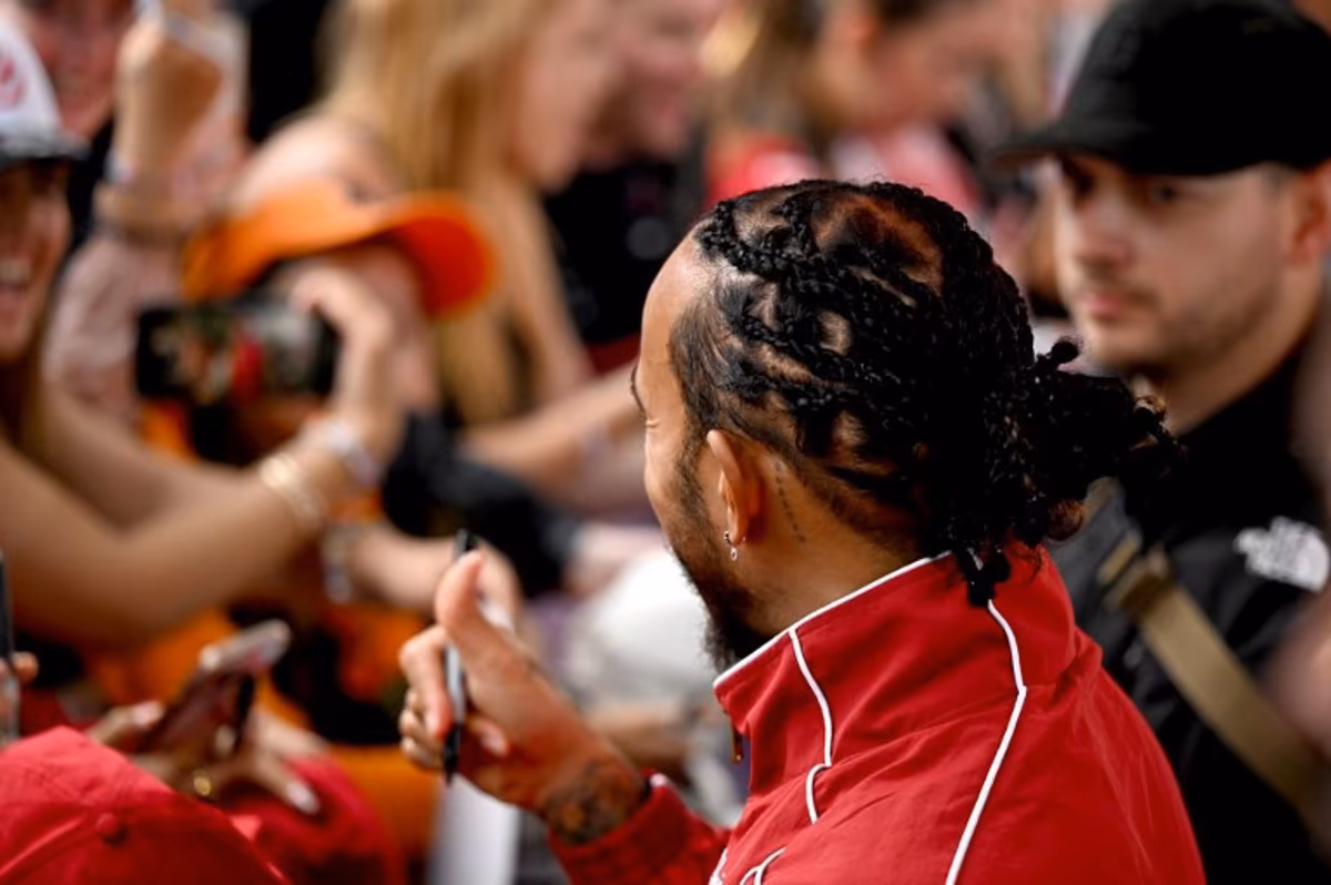 Ferrari's British driver Lewis Hamilton meets with fans as he arrives ahead of the Formula One Australian Grand Prix at the Albert Park Circuit in Melbourne on March 16, 2025. Saeed KHAN / AFP