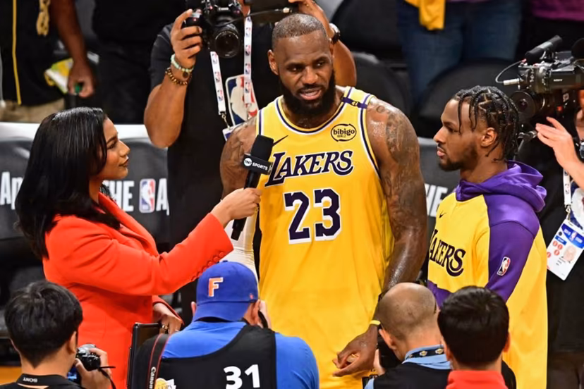 Los Angeles Lakers' US small forward #23 LeBron James (C) and his son, Los Angeles Lakers' US guard #09 Bronny James, speak with the press at the end of the NBA game season opener between the Los Angeles Lakers and the Minnesota Timberwolves at Crypto Arena in Los Angeles on October 22, 2024. LeBron and Bronny are the first father and son to play together in any NBA game. Frederic J. BROWN / AFP
