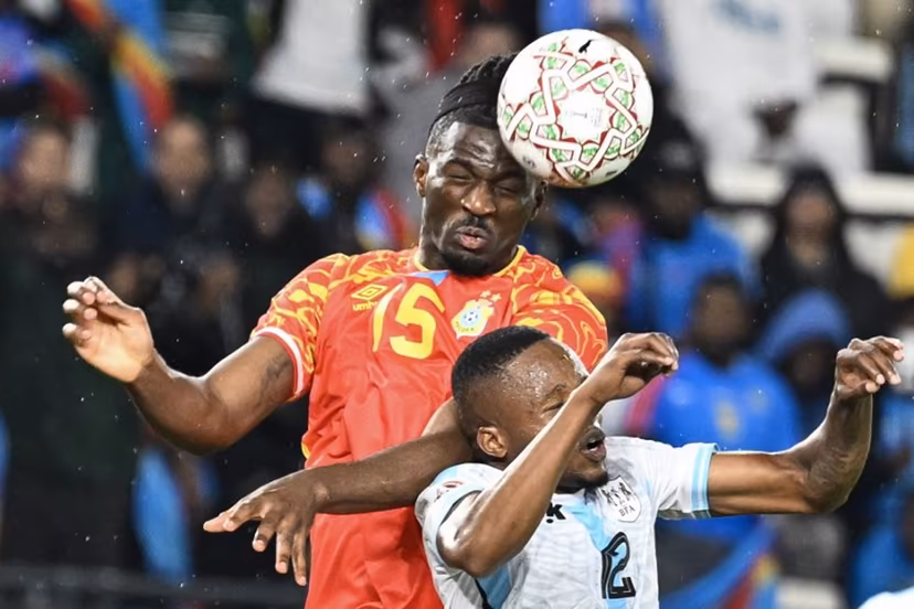 Democratic Republic Of Congo's defender #15 Rocky Bushiri and Botswana's defender #12 Mothusi Johnson vie during the Africa Cup of Nations (CAN) Group D football match between Botswana and Democratic Republic of Congo at El Madina Stadium in Rabat on December 30, 2025. SEBASTIEN BOZON / AFP