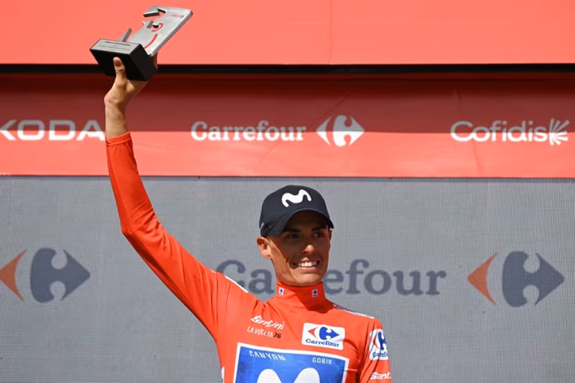Team Movistar's Spanish rider Enric Mas celebrates on the podium retaining the overall ranking leader's red jersey after 16th stage of the Vuelta a Espana 2026 cycling tour, a 181,1 km race between Cortegana and the Monastery of Santa Maria de la Rabida in Palos de la Frontera, on September 8, 2026. JORGE GUERRERO / AFP