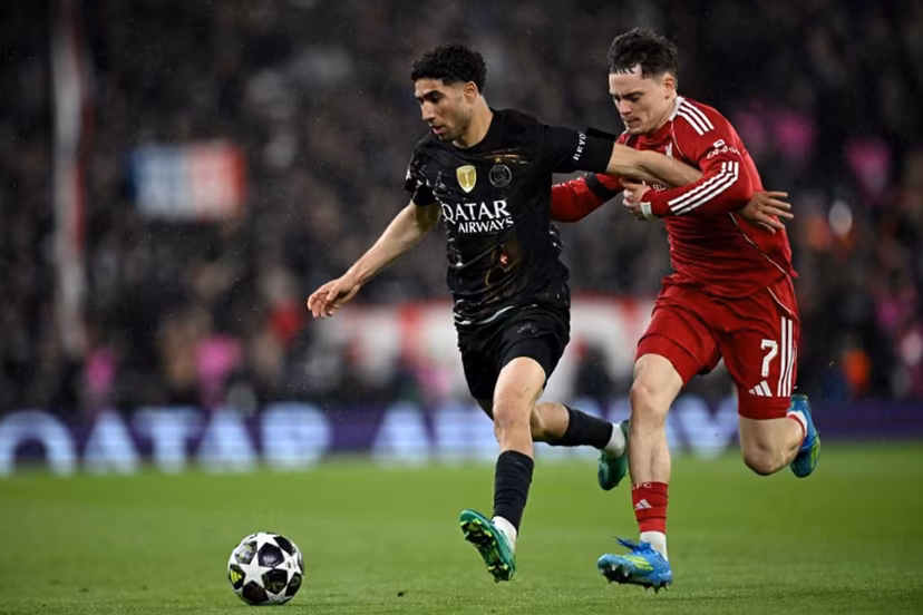 Paris Saint-Germain's Moroccan defender #02 Achraf Hakimi is put under pressure by Liverpool's German midfielder #07 Florian Wirtz during the UEFA Champions League quarter final, second-leg football match between Liverpool and Paris Saint-Germain at Anfield in Liverpool, north west England on April 14, 2026. Paul ELLIS / AFP