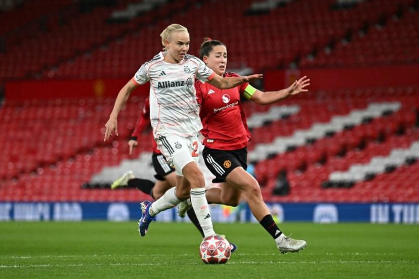 Bayern Munich's Danish forward #21 Pernille Harder (L) breaks past Manchester United's English defender #04 Maya Le Tissier (R) to score Bayern Munich's second goal during the UEFA Women's Champions League, Quarter Final first-leg football match between Manchester United and Bayern Munich at Old Trafford in Manchester, north west England, on March 25, 2025. Paul ELLIS / AFP