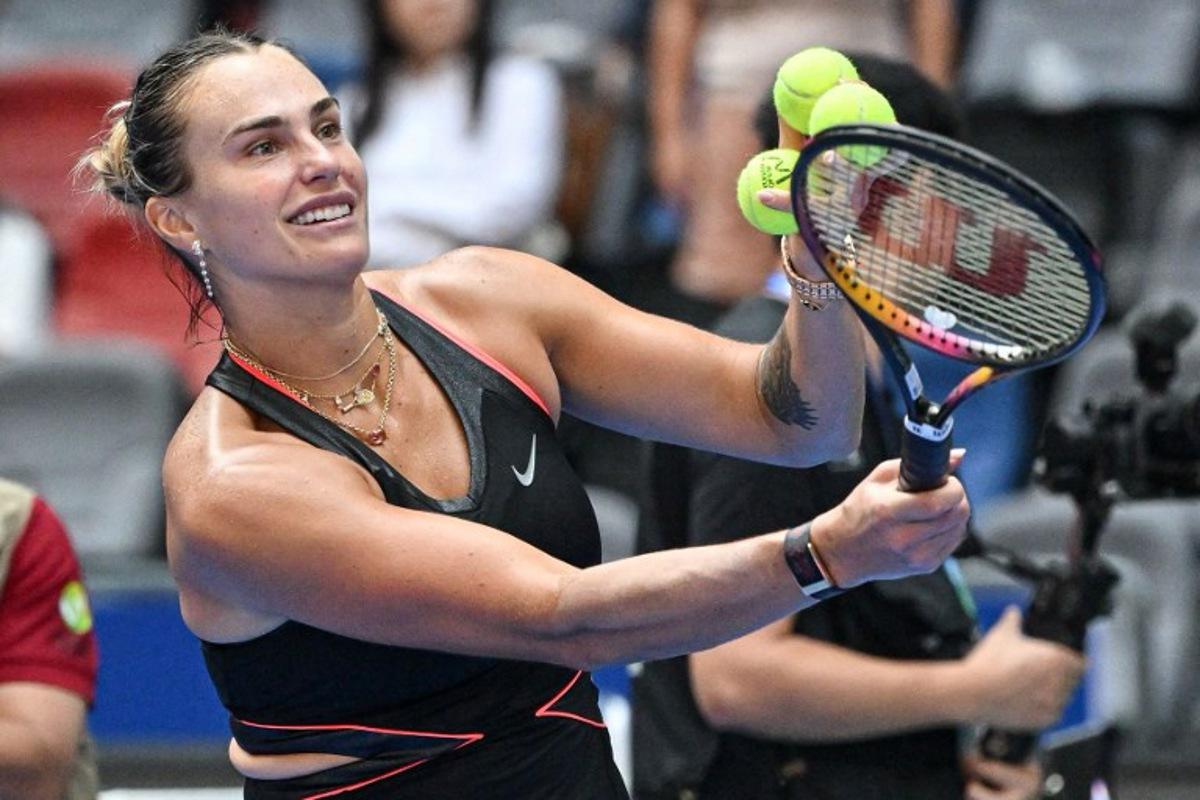 Belarus' Aryna Sabalenka prepares to hit balls to fans after winning against Kazakhstan's Elena Rybakina during their women's singles quarterfinal match at the Wuhan Open tennis tournament in Wuhan, Central China's Hubei province on October 10, 2025. ADEK BERRY / AFP