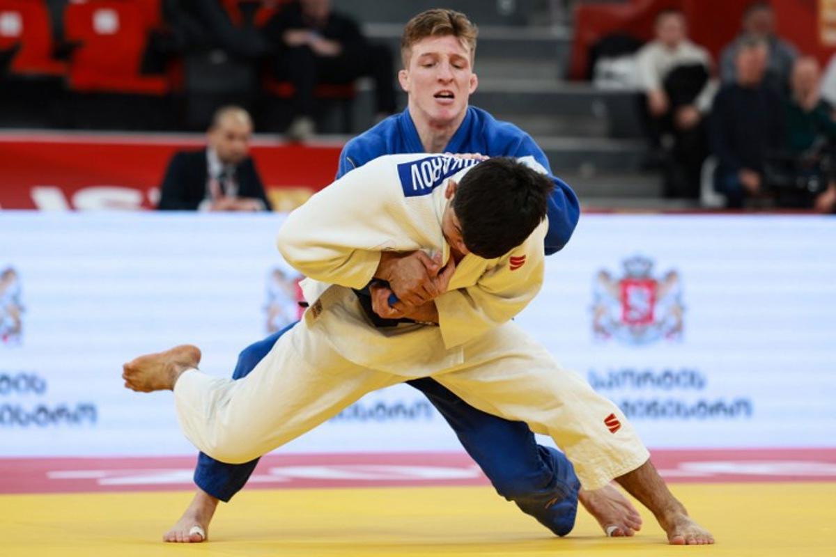 Uzbekistan's Samariddin Kuchkarov (white) competes against Belgium's Jorre Verstraeten in the men's under 60 kg bronze medal bout at the Tbilisi Grand Slam judo tournament in Tbilisi on March 20, 2026. Giorgi ARJEVANIDZE / AFP