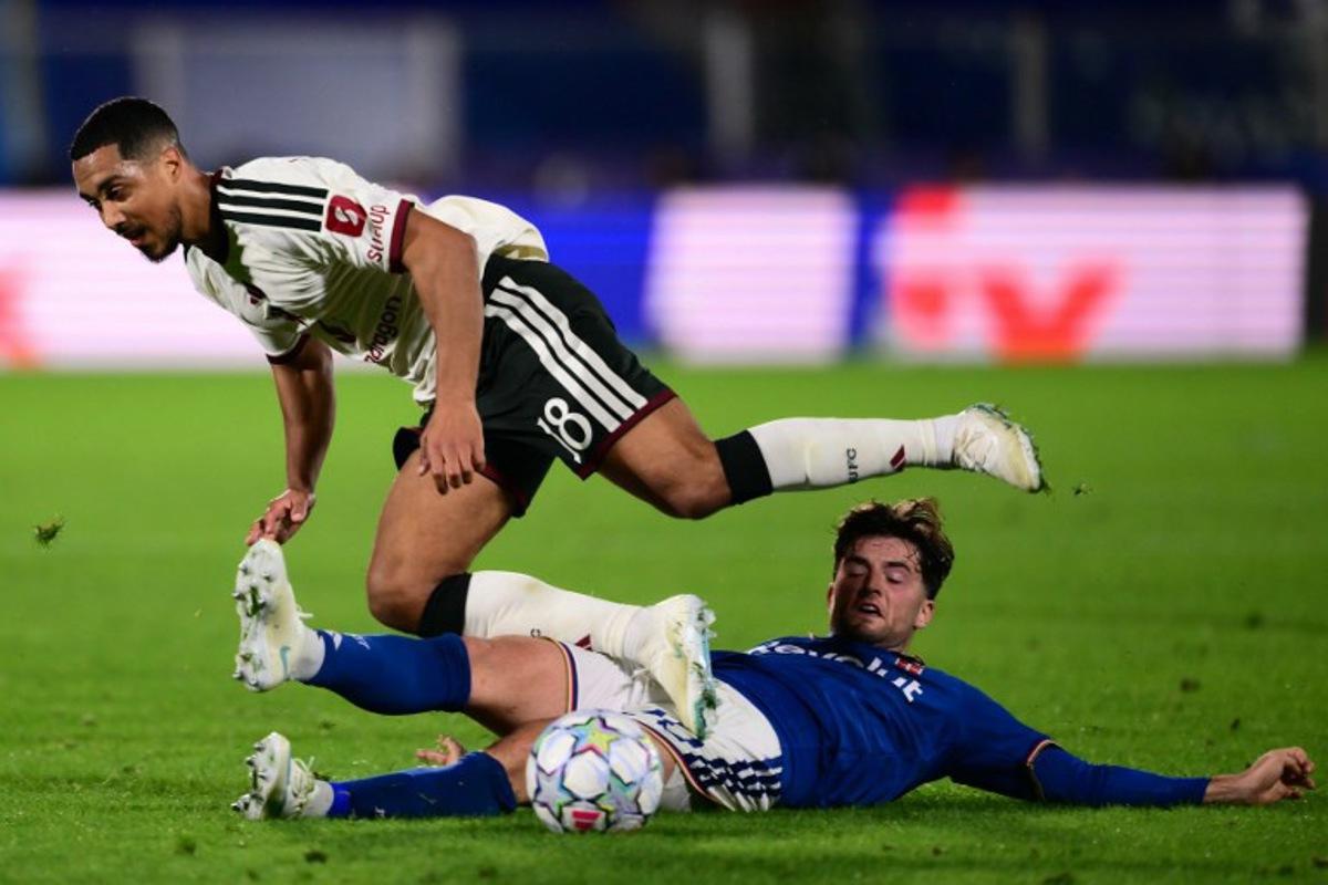 Manchester United's Belgian midfielder #18 Youri Tielemans (L) is tackled by Como's Croatian midfielder #20 Martin Baturina during the UEFA Champions League, league phase matchday 3, football match between Como 1907 and Manchester United at the Stadio Giuseppe Sinigaglia in Como, northen Italy on October 21, 2026. Marco BERTORELLO / AFP