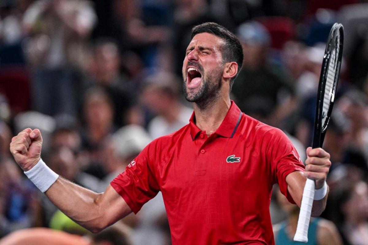 Serbia's Novak Djokovic celebrates after winning against Germany's Yannick Hanfmann during their men's singles match at the Shanghai Masters tennis tournament in Shanghai on October 5, 2025. Hector RETAMAL / AFP