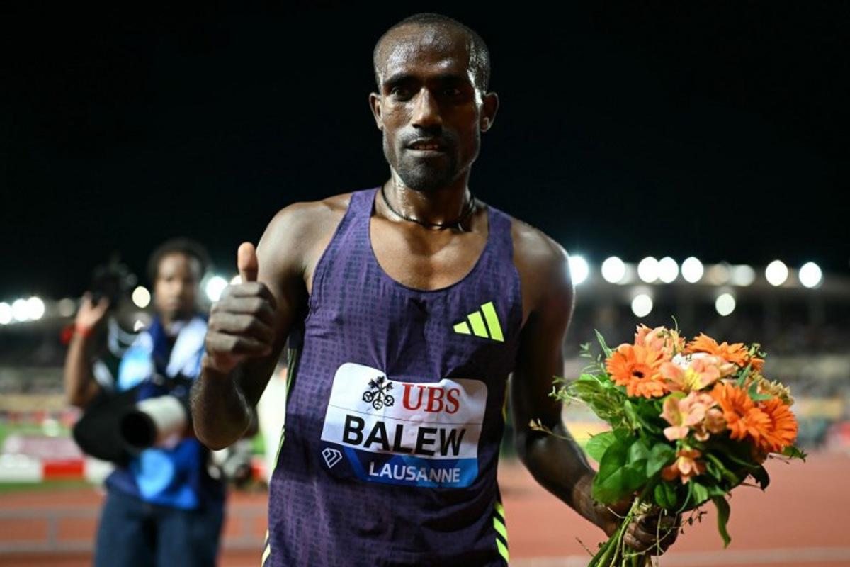 Bahrain's Birhanu Balew celebrates after winning the men's 5000m during the World Athletics Diamond League athletics meeting at the Stade Olympique de la Pontaise in Lausanne, on August 21, 2026. Fabrice COFFRINI / AFP